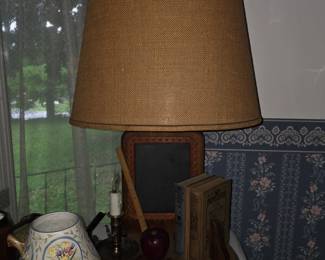 rustic, wooden table lamp features a base decorated 