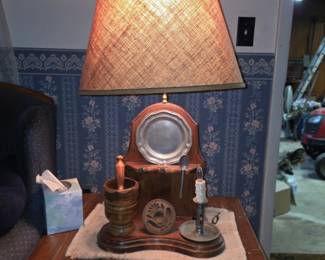 rustic, wooden table lamp features a base decorated 
