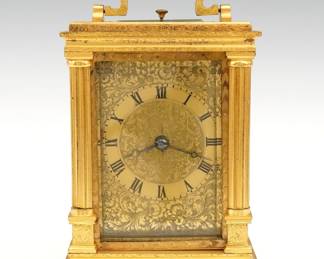 A late 19th century English Carriage clock. 8-day time and strike movement with platform escapement, bell strike and repeat on demand button, Brass dial with foliate engraving and Roman numerals. Fully engraved gilded Brass case with upper swing handle, full fluted corner columns, beveled glass front and sides, on a molded base. Minor wear, running when cataloged. 6 3/4" high overall. ESTIMATE $800-1,200