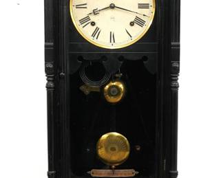 A late 19th century Seth Thomas Queen Anne model wall clock.  8-day time and strike movement with painted metal dial and Roman numerals, subsidiary seconds and damascened pendulum bob.  Mixed wood case with the original Ebonized finish features a galleried crown with turned finials over and arched door with reeded frame  flanked by turned columns over a bracket drop with gallery.  Original finish with some wear, dial wear, running when cataloged.  36 1/2" high.  ESTIMATE $300-400