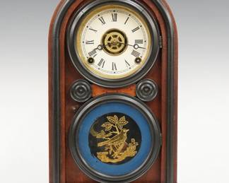 A late 19th century Ingraham Venetian model shelf clock.  8-day time, strike and alarm movement with papered metal dial and Roman numerals.  Walnut case with an arched top over an figure eight molded door with reverse painted lower glass and a simple molded base.  Paper label inside 80% intact.  Refinished with minor wear, re-papered dial, running when cataloged.  15 1/2" high.  ESTIMATE $100-150