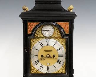 A late 18th century Scottish Bracket clock by James Cowan, Edinburgh (worked 1744-81).   8-day chain driven double fusee time and strike movement with Brass dial and Silvered chapter ring with Roman hour numerals and outer Arabic five minute track, cast foliate spandrels and fall regulation subsidiary dial marked "James Cowan, Edinburgh", upper Strike/No Strike lever, false pendulum and lower date apertures, nicely engraved backplate with foliate design, on demand pull string repeat.  Ebonized case with inverted bell top, Brass handle and Pineapple finials over a door with arched glass and inset Brass fretwork panels flanked by sides with circular upper glasses and shaped lower on a molded base with Brass bracket feet.  Original finish with minor wear, running when cataloged.  19 3/4" high overall.  ESTIMATE $3,000-4,000