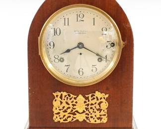 An early 20th century Seth Thomas 4-bell Sonora chime mantel clock. 8-day time and strike #90B movement with quarter hour striking on four Sonora bells in Westminster Cathedral chimes, convex Silvered dial with Arabic numerals. Mahogany case with Gothic arched top, Brass dial door over a gilded plaque and molded base. Older finish with minor wear, some dial wear, running when cataloged. 14 1/4" high. ESTIMATE $200-300
