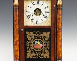 A 19th century Seth Thomas mantel clock.  30-hr weight driven time and strike movement with painted metal dial and Roman numerals.  Mahogany case with a flat top over a single door with reverse painted lower glass flanked by painted pilasters on a simple plinth base.  Paper label 30% intact.  Older refinishing with minor wear, dial wear, restored lower glass, running when cataloged.  26" high.  ESTIMATE $100-150