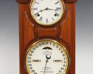 A late 19th century Ithaca No. 7 Model Library shelf clock.  8-day time and strike movement with lower calendar mechanism and apertures indicating day and month, papered metal dials with Roman/Arabic numerals.  Walnut case with a molded pediment crest above circular dial glasses with Brass bezels and molded panels on a molded base.  Refinished with slight wear, re-papered dials and rollers, running when cataloged.  22 1/4" high.  ESTIMATE $200-300