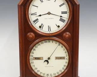 A late 19th century Seth Thomas Parlor Calendar No. 5 model shelf clock.  8-day time and strike movement with lower calendar mechanism, painted metal dials with Roman/Arabic numerals and apertures indicating day and month.  Walnut case with Ebonized detail features a molded Octagon top over a single door with circular dial glasses on a molded base.  Old Grinnell Iowa retailer's label verso.  Nicely refinished with slight wear, restored dials, running when cataloged.  20 1/4" high overall.  ESTIMATE $300-400
