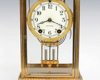 A turn of the century Seth Thomas Empire No. 14 model crystal regulator. 8-day spring driven time and strike movement with flat porcelain dial and Arabic numerals and faux Mercury pendulum. Brass case with gadrooned and foliate detail, beveled glass doors and sides on a scrolled base. Some wear, running when cataloged. 11 3/4" high overall. ESTIMATE $200-300