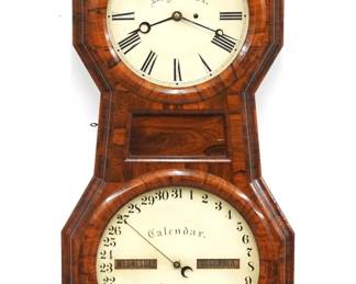 A 19th century Seth Thomas Office Calendar No. 1 model wall clock. 8-day weight driven time only movement with maintaining power and lower caendar mechanism, painted metal dials with Roman/Arabic numerals. Rosewood case with single long door and molded circular dial glasses. Paper label inside door 60% intact. Nice older refinishing with minor wear, tiny veneer imperfections, old Dial House dial restorations, rollers dark, running when cataloged. 40" high. ESTIMATE $1,000-2,000