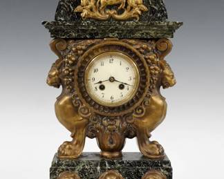 A late 19th century Lenzkirch Library clock.  8-day time and strike movement with convex porcelain dial and Arabic numerals, serial #998321 indicates a production date of 1893.  Bronze and Verde marble case with an arched molded top with Centaur medallion over a bronze movement housing with Lion supports and marble base with bronze busts of famous authors and gadrooned feet.  Minor wear, crack in dial glass, lacks rear cover, running when cataloged.  16 1/2" high.  ESTIMATE $300-400  