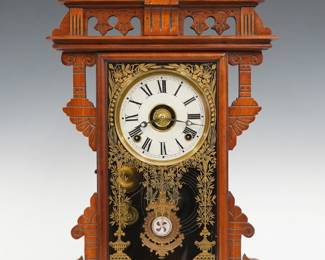 A late 19th century Welch Eclipse model shelf clock.  8-day time, strike and alarm movement with papered metal dial and Roman numerals, fancy "Eclipse" pendulum.  Walnut case with a shaped crest and pierced detail over a molded door with stenciled glass and a molded base.  Refinished with minor wear, some dial wear, running when cataloged.  23 3/4" high.  ESTIMATE $100-150