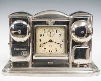 An early 20th century Darche Electric Co. boudoir clock with incorporated nightlight and coin bank. 30-hour spring driven mechanical movement with painted metal dial and Roman numerals, battery powered alarm bell. Nickel plated steel case with central clock and nightlight flanked by bank and alarm pedestals with domed covers. Old finish with minor wear, lacks battery, wound tight, not running when cataloged. 8 1/4" high. ESTIMATE $300-400