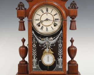 A 19th century Kroeber Kansas model Victorian shelf clock.  8-day time and strike movement with papered metal dial and Roman numerals, fancy pendulum with glass insert.  Walnut case with an arched molded top above a single arched door with stenciled glass, flanked by turned drops and finials on a molded base.  Paper label on back fragment only.  Older finish with minor wear, running when cataloged.   19 3/4" high.  ESTIMATE $200-300