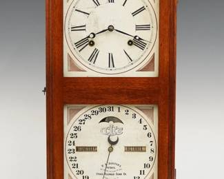 A late 19th century Ithaca No. 10 Farmer's Model shelf clock.  8-day time and strike movement with lower calendar mechanism and apertures indicating day and month, papered metal dials with Roman/Arabic numerals.  Walnut case with a flat molded top above a single door with square dial glasses on a molded base.  Refinished with slight wear, dial wear, replaced back board, running when cataloged.  21 1/4" high.  ESTIMATE $100-200