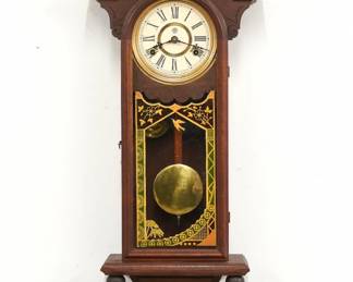 A late 19th century New Haven Winnipeg model wall clock.  8-day time and strike movement with papered metal dial and Roman numerals.  Walnut case with carved detail features and arched crest on a molded crown with turned finials over an arched door with molded frame and reverse painted glass over a tapered drop.  Paper label on back 50% intact.  Refinished with minor wear, dial re-papered, running when cataloged.  33 3/4" high.  ESTIMATE $200-300