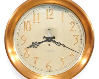 An early 20th century Waltham Bronze Gallery clock.  8-day time only spring driven movement with platform escapement, 12" Silvered dial with applied Bronze Arabic numerals marked "Waltham" with F/S adjustment, serial #30032.  Bronze case with hinged molded bezel.  Minor wear, some dial oxidation, hanging supports have been added to the back, running when cataloged.  13 3/4" diameter overall.  ESTIMATE $2,000-3,000