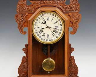 A late 19th century Waterbury Rochester model shelf clock.  8-day time and strike movement with simple calendar, papered metal dial with Roman/Arabic numerals.  Walnut case with pressed carved detail features shaped top above a single door with molded frame flanked by shaped ears on a molded base.  Interior paper label 50% intact.  Refinished with minor wear, re-papered dial, running when cataloged.  26 3/4" high.  ESTIMATE $200-300