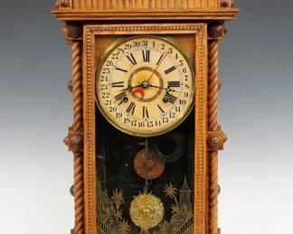 A late 19th century Gilbert Long Branch Model shelf clock.  8-day time and strike movement with simple calendar papered metal dial with Roman/Arabic numerals.  Oak case with roped detail features a molded top with turned finials above a single door with stenciled glass and molded frame flanked by rope columns on a molded egg and dart base.  Interior paper label 80% intact.  Refinished with minor wear, dial wear, replaced finials, running when cataloged.  28 1/2" high.  ESTIMATE $200-300