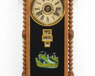 A late 19th century Gilbert Berkshire model wall clock.  8-day time and strike movement with papered metal dial and Roman numerals, lower calendar mechanism with apertures indicating day, month and date.  Oak case with a shaped crest over a single door single door with reverse painted glass flanked by spool turned side columns above a shaped lower drop.  Interior and verso labels 50% intact.  Older refinishing with some wear, running when cataloged.  37 1/2" high.  ESTIMATE $200-300