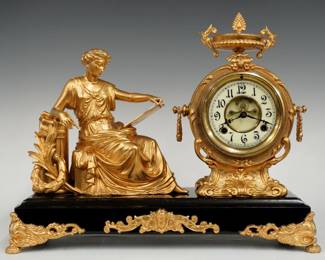 A late 19th century New Haven Clotho model figural mantel clock.  8-day time and strike movement with visible escapement and two part porcelain dial with Arabic numerals, fancy filigree hands.  Black enameled iron base with cast Spelter figure, case, applique and feet.  Refinished with minor wear, running when cataloged.  15 3/4" high overall.  ESTIMATE $300-400