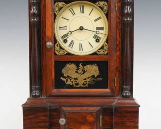 A late 19th century Atkins London Model shelf clock.  8-day spring driven time and strike movement with painted metal dial and Roman numerals.  Rosewood case with molded crown over an upper door with clear dial glass, stenciled corners and lower glass flanked by turned pilasters over lower paneled door on a molded plinth base.  Interior paper label 80% intact.  Refinished with slight wear, re-painted dial, running when cataloged.  16 1/2" high.  ESTIMATE $100-150