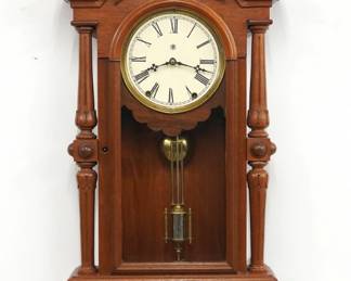 A late 19th century Kroeber Regulator No. 30 model wall clock.  8-day time and strike movement with papered metal dial and Roman numerals.  Walnut case with carved detail features a shaped crest over an arched door flanked by turned columns over a shaped drop with Burl Walnut detail.  Paper label on back 80% intact.  Older refinishing with minor wear, dial re-papered, running when cataloged.  36 1/2" high.  ESTIMATE $400-600