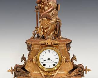 A turn of the century Seth Thomas Sons & Co. figural mantel clock. 8-day spring driven time and strike movement with flat porcelain dial and Roman numerals, serial # 34904. Cast spelter case with a figure of a musician on a base with Gryphons and Egyptian masks. Two tone finish with some wear, running when cataloged. 17" high overall. ESTIMATE $200-300