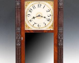 A 19th century American Column & Splat shelf clock.  30-hr wooden plate time and strike movement, painted wooden dial with Arabic numerals and floral detail.  Mahogany case with a broken arch crest with turned finials over a single door with clear dial glass and two mirrored lower glasses flanked by carved pilasters all supported by carved paw feet.  Refinished with minor wear, restored crest and finials, running when cataloged.  40 1/2" high.  ESTIMATE $200-300