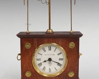A late 20th century Ignatz Flying Pendulum novelty clock by Horolovar.  8-day wind up movement with "Jerome & Co." paper dial and Roman numerals.  Mixed wood case with metal mounts.  Slight wear, one brass foot is bent, includes original shipping box, running when cataloged.  10" high.  ESTIMATE $100-150