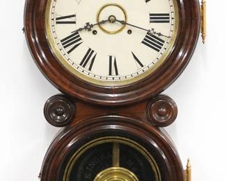 A late 19th century Ingraham Reflector model clock.  8-day time and strike movement with papered metal dial and Roman numerals.  Figure eight Rosewood case with molded doors and turned bosses, lower door with reverse painted glass.  Interior paper label 60% intact.  Older refinishing with minor wear, re-papered dial, running when cataloged.  29 1/2" high.  ESTIMATE $300-400