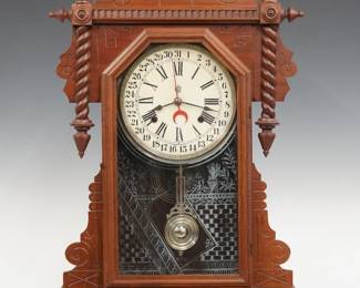 A late 19th century Waterbury Buffalo model shelf clock.  8-day time and strike movement with simple calendar, painted metal dial with Roman/Arabic numerals.  Walnut case with roped detail features a shaped top with turned finials above a single door with stenciled glass and molded frame flanked by rope columns on a molded base.  Paper labels on back 50% intact.  Refinished with minor wear, minor dial wear, running when cataloged.  26 3/4" high.  ESTIMATE $200-300