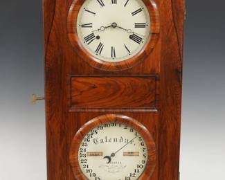A 19th century Seth Thomas Parlor Calendar No. 1 model shelf clock.  8-day weight driven time and strike Lyre movement with lower calendar mechanism, painted metal dials with Roman/Arabic numerals and apertures indicating day and month.  Rosewood case with arched top over a long door with circular dial glasses on a simple molded base.  Paper label on back of door 80% intact.  Older refinishing with minor wear, restored Dial House dials, running when cataloged.  33" high overall.   ESTIMATE $600-800
