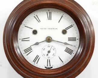 A late 19th century Seth Thomas Wardroom model wall clock.  1-day time and strike movement with lever escapement and Ships Bell strike, porcelain dial with Roman numerals and subsidiary seconds.  Turned Mahogany housing.  Some wear, dial flakes, crack in door glass, running when cataloged.  8 3/4" diameter.  ESTIMATE $300