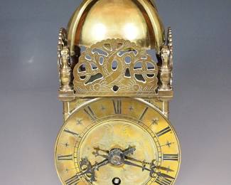 A mid 20th century Swiss Lantern clock by Buren. 8-day time only movement with platform escapement and Brass dial with Roman numerals. Brass case with Bell top and engraved decoration, hinged rear door. Minor wear, running when cataloged. 10" high overall. ESTIMATE $200-300