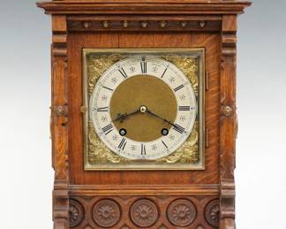 A late 19th century Lenzkirch bracket clock, retailed by F. T. Depree, Exeter (England).  8-day time and strike movement with quarter hour Bim-Bam chiming on two coiled gongs, Brass dial with cast spandrels and Silvered chapter ring with Roman numerals, serial # 1 million, 72370 indicates a production date of 1895.  Oak case with a pediment top and turned finials, Brass dial door with beveled glass flanked by shaped pilasters and paneled sides with Brass lift handles on a bracket footed base.  Older finish with slight wear, recently serviced and running when cataloged.  17" high overall.  ESTIMATE $600-800