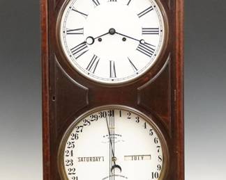 A late 19th century Ithaca No. 3 Bank Model shelf clock.  8-day dual weight time only movement with lower calendar mechanism and apertures indicating day and month, papered metal dials with Roman/Arabic numerals.  Walnut case with pediment top features a single long door with applied panels and molded detail, circular dial glasses with Brass bezels on a molded base.  Old dark finish with some wear, re-papered dials, running when cataloged.  39 1/4" high.  ESTIMATE $600-800