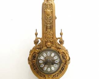 A late 19th century French Bronze Cartel clock by Eugène Baguès (later known for Maison Baguès).  8-time and strike movement with cast Brass dial, porcelain markers and Roman numerals, serial #15111, fitted with E. Lourdelet's patented internal adjustment lever.  Cast Bronze Baroque style case with gilded finish features mythical beasts, winged maidens and a satyr mask with reticulated panels and a shaped lower drop.  Some finish wear, running when cataloged.  38 1/4" high overall.  ESTIMATE $600-800