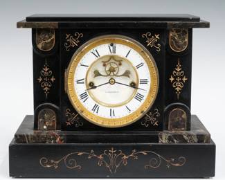 A 19th century E. N. Welch Paola model shelf clock. 8-day time and strike Patti movement with porcelain dial, visible escapement and Roman numerals. Black marble case with incised gilded decoration and painted detail features a flat top on a stepped base. Faded label on back 10% intact. Minor wear, dial hairlines running when cataloged. 9 1/2" high. ESTIMATE $100-200