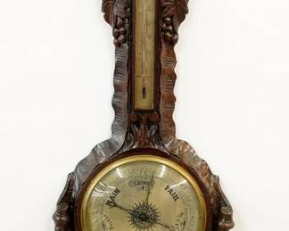 A 19th century English Victorian period wheel barometer.  Upper thermometer and lower barometer with Silvered dials and engraved indexes.  Shaped Oak case with carved vintage design.  Refinished with some wear, minor damage and old repairs, working, accuracy unknown.  41 1/4" high overall.  ESTIMATE 200-300  NOTE: This item contains Mercury, check shipping restrictions before purchase, pickup available.