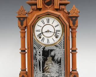 A turn of the century Ingraham Peerless model shelf clock.  8-day time and strike movement with papered metal dial and Roman numerals.  Maple case with painted detail features a shaped crest  over a molded door with stenciled glass flanked by turned columns and a shaped molded base.  Refinished with minor wear, dial re-papered, running when cataloged.  22" high.  ESTIMATE $100-150