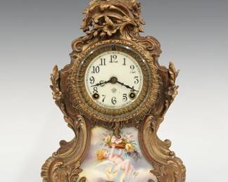 A turn of the century Ansonia Trianon model mantel clock. 8-day spring driven time and strike movement with flat porcelain dial and Arabic numerals. Louis XV Style cast spelter case with foliate detail and inset porcelain panel on a scrolled base. Original Bronze finish with some wear, crack and crazing to panel, running when cataloged. 14 1/4" high overall. ESTIMATE $100-150