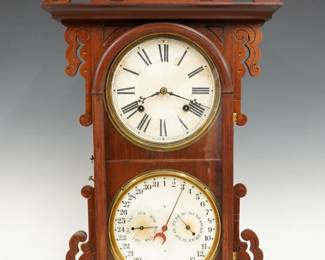 A late 19th century Welch "Arditi" model Calendar shelf clock.  8-day time and strike movement with lower calendar mechanism and papered metal dials with Roman/Arabic numerals and subsidiary dials indicating day and month.  Walnut case with shaped crest and ears, single molded door on a molded plinth base. Interior paper instruction label 50% intact.  Refinished with minor wear, some dial wear, running when cataloged.  28 3/4" high.  ESTIMATE $300-400