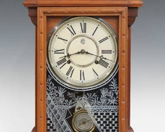 A late 19th century Waterbury Albany model shelf clock.  8-day time and strike movement with papered metal dial and Roman numerals.  Walnut case with a shaped crest and turned finials over a molded door with stenciled glass flanked by molded pilasters and a shaped molded base.  Paper label on back 20% intact.  Refinished with minor wear, minor dial wear, running when cataloged.  23 1/2" high.  ESTIMATE $100-150