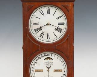 A late 19th century Ithaca No. 10 Farmer's Model shelf clock.  8-day time and strike movement with lower calendar mechanism and apertures indicating day and month, papered metal dials with Roman/Arabic numerals.  Walnut case with a scrolled crest above a single door with circular dial glasses and molded panels on a molded base.  Old finish with minor wear, dial wear, running when cataloged.  25 3/4" high.  ESTIMATE $200-300
