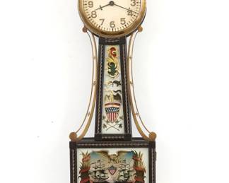 A 1930's miniature Waltham Presentation Banjo clock, Perry's Victory, Lake Erie model. 8-day time only stem wind movement with lever escapement and painted dial with Arabic numerals.  Mahogany case with turned acorn finial, Brass side arms and rope trim, original reverse painted throat glass and lower glass.  Original finish with wear and crazing, lack rear F/S cover, running when cataloged.   21" high.  ESTIMATE $100-150