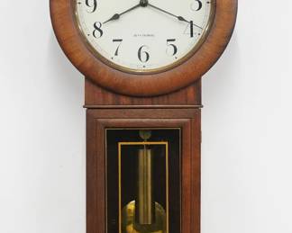 A 20th century Seth Thomas No. 2 model Regulator Wall Clock.  8-day time only weight driven movement with trapezoidal plates and maintaining power, painted metal dial with Arabic numerals and subsidiary seconds. Mahogany case with circular upper molded door and rectangular lower with reverse painted glass over a shaped drop.  Refinished with minor wear, running when cataloged.  35 1/2" high.  ESTIMATE $300-500