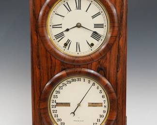 A late 19th century Seth Thomas Parlor Calendar No. 3 model shelf clock.  8-day time and strike movement with lower calendar mechanism, papered metal dials with Roman/Arabic numerals and apertures indicating day and month.  Rosewood grained Cherry case with a pediment crest over a single door with circular dial glasses on a molded base.  Paper label on back of door 80% intact.  Older refinishing with minor wear, re-papered dials, running when cataloged.  26 3/4" high overall.   ESTIMATE $200-300