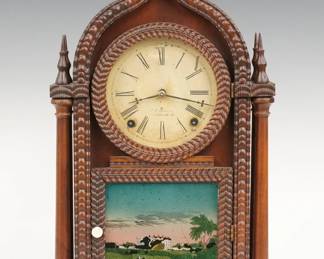 A mid 19th century J.C. Brown Ripple Front shelf clock. 8-day time and strike movement with painted metal dial and Roman numerals, marked "J.C. Brown". Rosewood four column O. G. Gothic (Onion Top) case with single door, circular dial glass and reverse painted lower glass. Paper label inside back 50% intact. Older refinishing with some wear, replaced old dial with some wear, paint flakes to lower glass, running when cataloged. 19 3/4" high. ESTIMATE $400-600