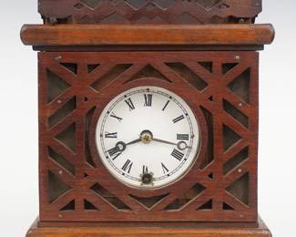 A 19th century Charles Kirk shelf clock.  30-hour time only movement with balance wheel lever escapement, double escape wheels and iron back plate, papered metal dial with Roman numerals.  In a craftsman made Oak case with mortise and tenon construction and fret sawn decoration.  Old finish with some wear, dial re-papered, running when cataloged.  10 1/4" high.  ESTIMATE $100-150