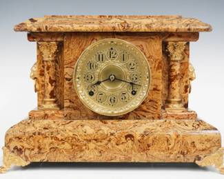A turn of the century Seth Thomas Adamantine mantel clock.  8-day time and strike movement with embossed dial and bezel, Arabic numerals.  Marbleized Adamintine finish with gold metal castings.  Paper label on back 50% intact.  Case cleaned and polished with slight wear, castings re-painted, running when cataloged.  11 3/4" high.  ESTIMATE $150-200
