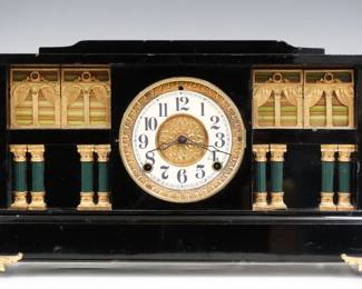 A turn of the century Ingraham de Soto model mantel clock.  8-day time and strike movement with paper and convex dial and Arabic numerals.  Black enamel finish with decorated panels and marbleized columns, gold metal castings.  Minor case wear, castings re-painted, running when cataloged.  11" high.  ESTIMATE $100-150